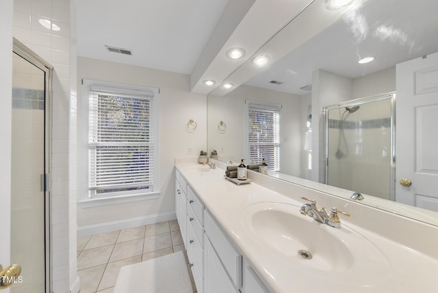 50 Tyler Ct, Henderson, NC 27537 - bathroom with tile patterned flooring, a shower stall, baseboards, double vanity, and recessed lighting