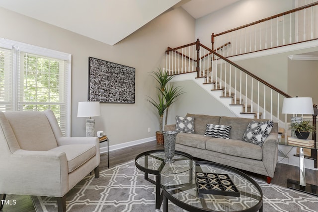 living room with stairway, wood finished floors, and baseboards