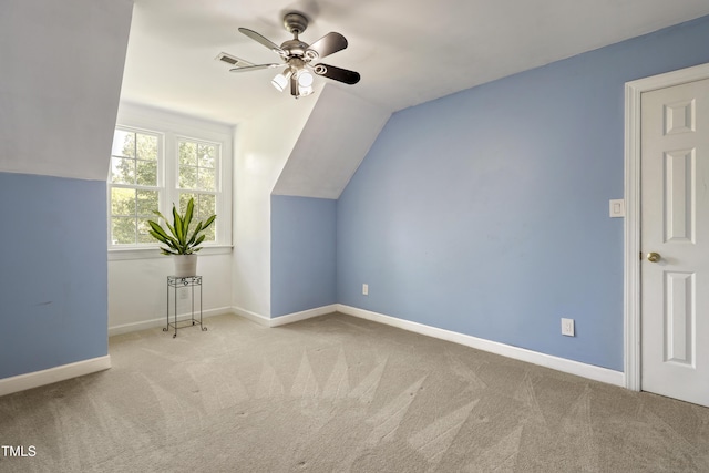 bonus room with ceiling fan, vaulted ceiling, carpet flooring, and baseboards