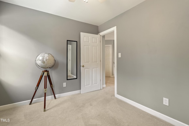 unfurnished bedroom featuring carpet and baseboards