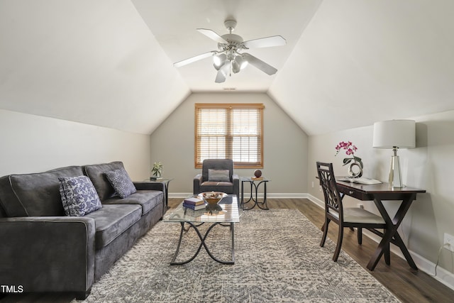 living area with wood finished floors, a ceiling fan, vaulted ceiling, and baseboards