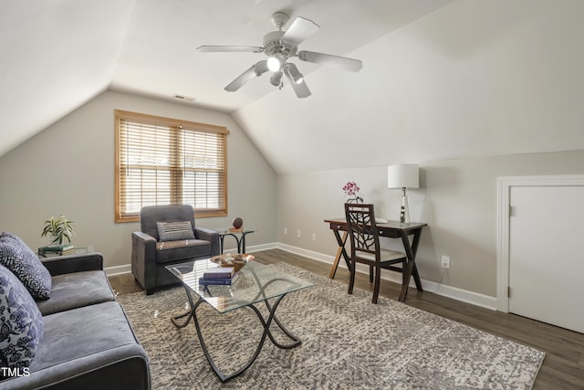 living area featuring wood finished floors, vaulted ceiling, ceiling fan, and baseboards