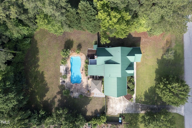 view of subject property with a pool