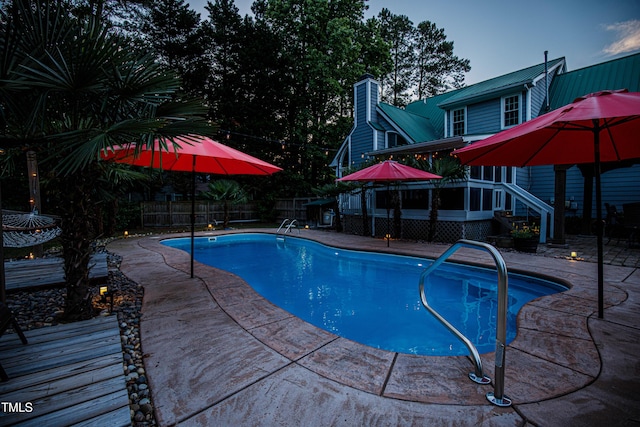 view of pool featuring a deck, a fenced backyard, and a patio area