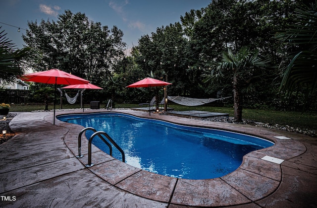 swimming pool featuring a patio area and fence
