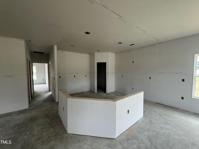 215 Creeks Edge Dr, Pikeville, NC 27863 - kitchen with concrete flooring, white cabinets, and a center island