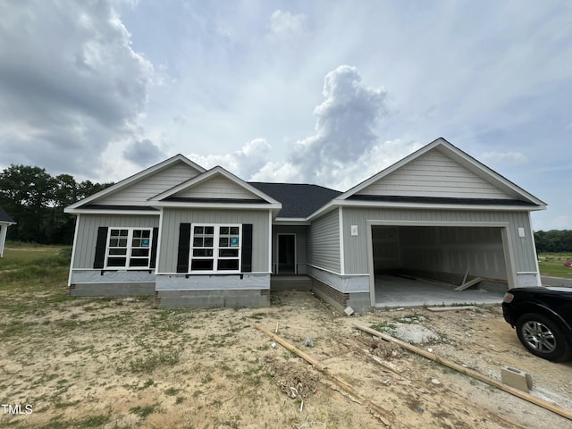 215 Creeks Edge Dr, Pikeville, NC 27863 - unfinished property featuring a garage, driveway, and board and batten siding