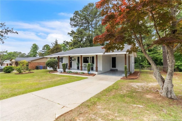 ranch-style home featuring concrete driveway, a porch, and a carport