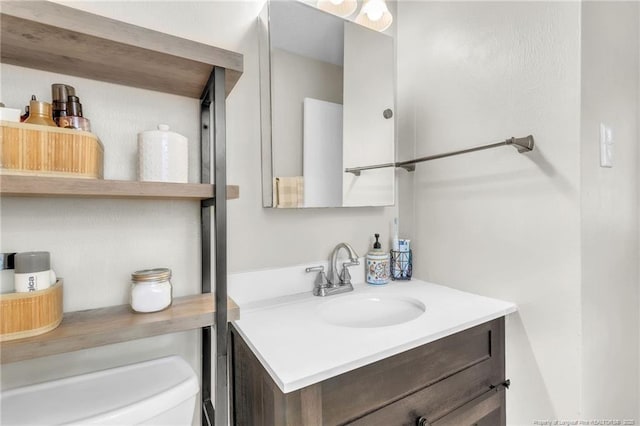 bathroom featuring vanity and toilet