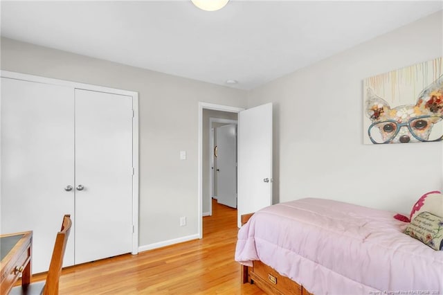 bedroom with light wood finished floors and baseboards