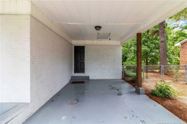 view of patio with fence and a carport