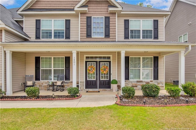 1401 Draw Bridge Ln, Fayetteville, NC 28312 - view of front of home with a porch, stone siding, and a front yard