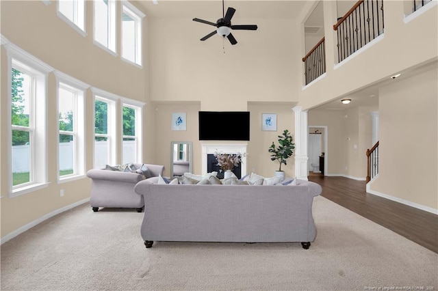 1401 Draw Bridge Ln, Fayetteville, NC 28312 - living area with a high ceiling, ceiling fan, healthy amount of natural light, a fireplace, and baseboards