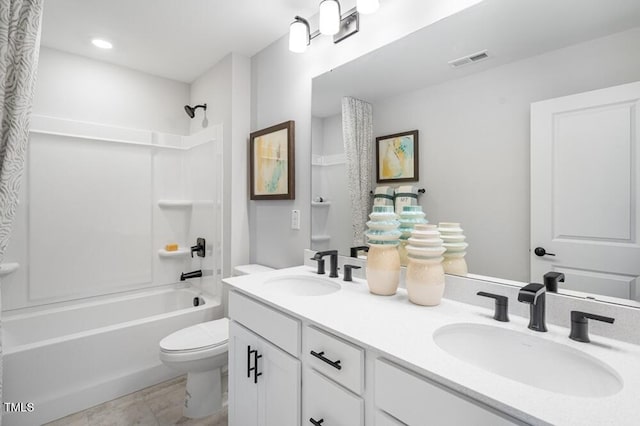full bath with toilet, washtub / shower combination, and double vanity