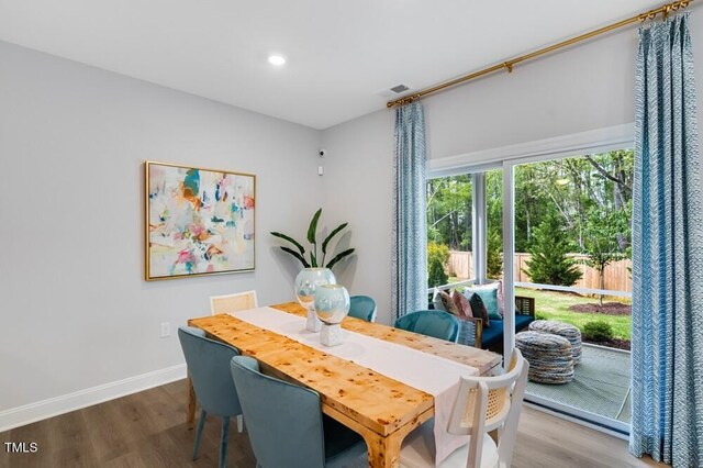dining room featuring wood finished floors, baseboards, and recessed lighting