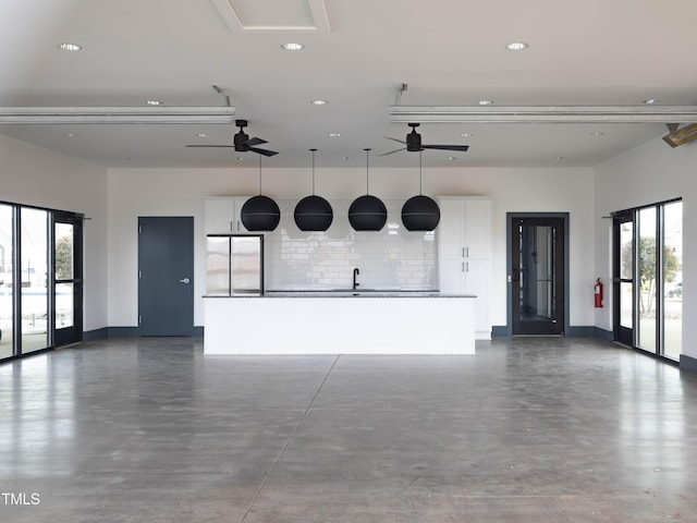 1036 Channel Drop Lp, Zebulon, NC 27597 - garage featuring ceiling fan, recessed lighting, baseboards, a sink, and stainless steel refrigerator