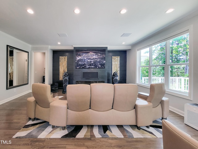 living area featuring ornamental molding, baseboards, recessed lighting, and wood finished floors