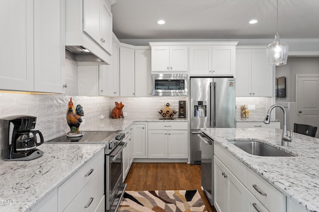 kitchen featuring appliances with stainless steel finishes, a sink, white cabinetry, and recessed lighting