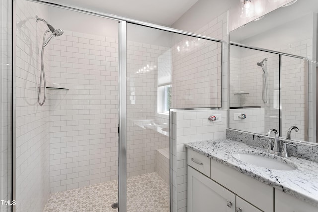 full bath featuring a stall shower and vanity