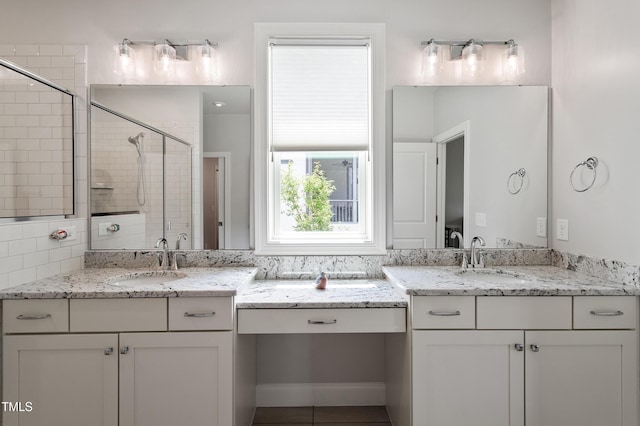 full bathroom with a stall shower, two vanities, and tile patterned floors