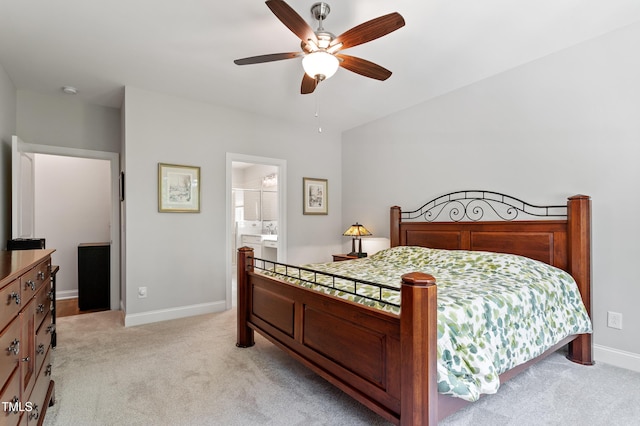 bedroom with light carpet, baseboards, a ceiling fan, and connected bathroom