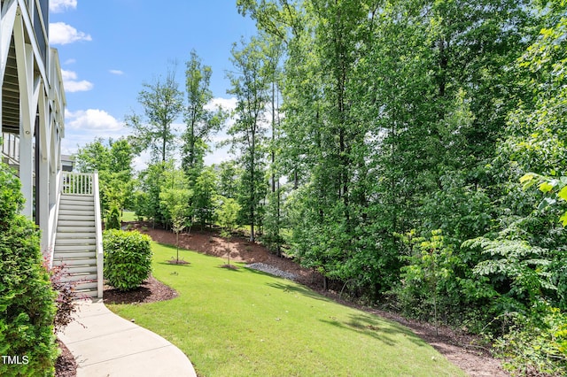 view of green lawn with stairway