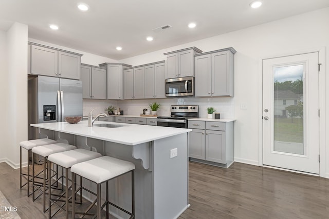 69 Curling Creek Dr Unit I286, Clayton, NC 27527 - kitchen featuring appliances with stainless steel finishes, a sink, gray cabinets, dark wood finished floors, and recessed lighting