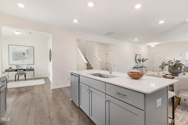 69 Curling Creek Dr Unit I286, Clayton, NC 27527 - kitchen with gray cabinets, dishwasher, a sink, a breakfast bar, and recessed lighting