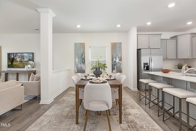69 Curling Creek Dr Unit I286, Clayton, NC 27527 - dining area with dark wood-type flooring, baseboards, recessed lighting, and decorative columns