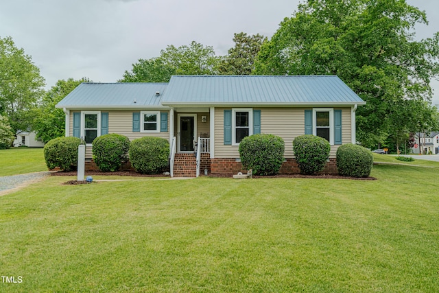 view of front of property featuring a front yard and metal roof