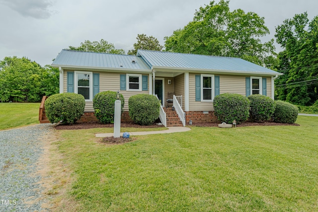 single story home featuring a front yard and metal roof
