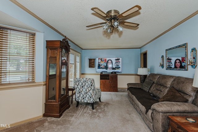 living room with carpet flooring, crown molding, a textured ceiling, ceiling fan, and baseboards