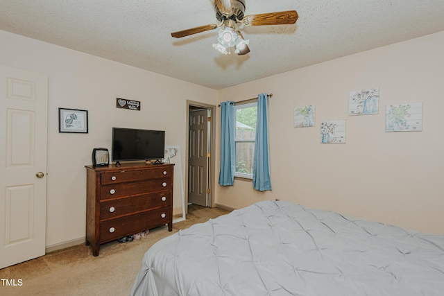 bedroom with carpet floors, baseboards, a textured ceiling, and ceiling fan