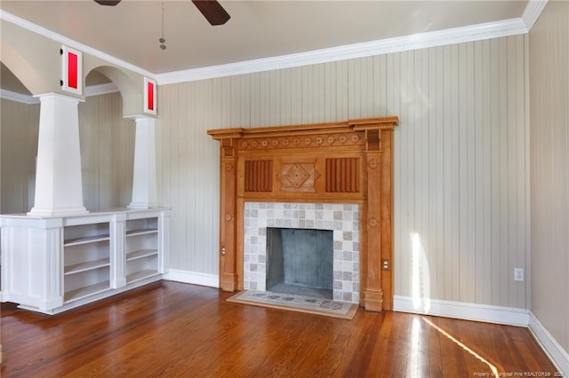 305 N Fayetteville St, Parkton, NC 28371 - unfurnished living room with wood finished floors, baseboards, a ceiling fan, ornamental molding, and a tile fireplace
