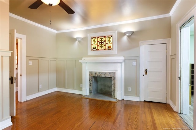 305 N Fayetteville St, Parkton, NC 28371 - unfurnished living room featuring crown molding, a ceiling fan, wood finished floors, a decorative wall, and a fireplace