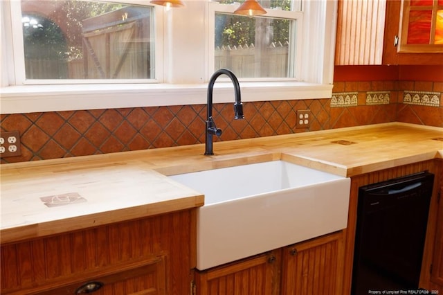 305 N Fayetteville St, Parkton, NC 28371 - kitchen view of wood counters, black dishwasher, a sink, and backsplash