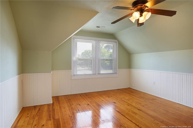 305 N Fayetteville St, Parkton, NC 28371 - additional living space with wainscoting, wood-type flooring, vaulted ceiling, and ceiling fan