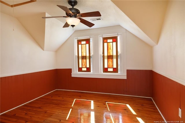 305 N Fayetteville St, Parkton, NC 28371 - bonus room with a wainscoted wall, wood finished floors, vaulted ceiling, and ceiling fan