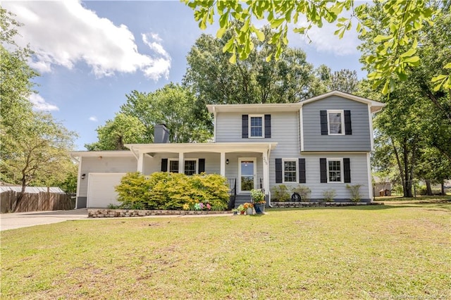 traditional-style home with covered porch, concrete driveway, an attached garage, and a chimney