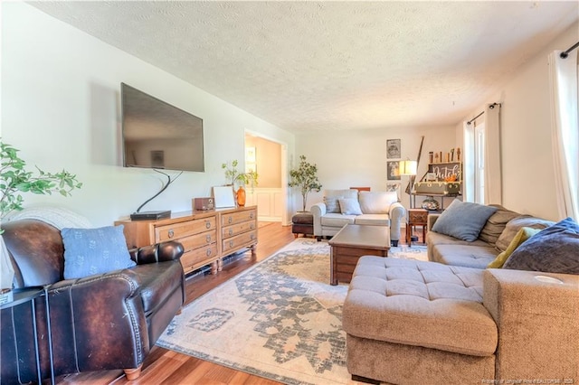 living room with wood finished floors and a textured ceiling