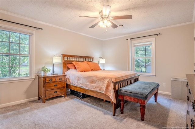 bedroom featuring a textured ceiling, baseboards, light carpet, crown molding, and ceiling fan