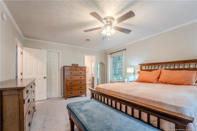 bedroom with light colored carpet, crown molding, a textured ceiling, a ceiling fan, and ensuite bath