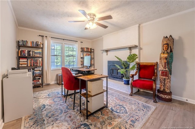 office featuring wood finished floors, ceiling fan, a textured ceiling, crown molding, and baseboards