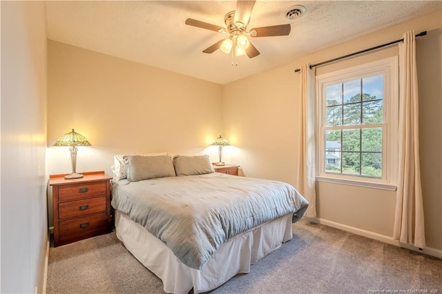bedroom with baseboards, carpet floors, and a ceiling fan