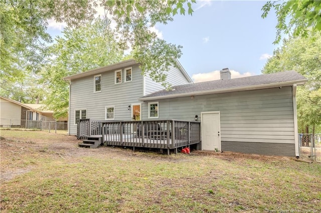rear view of property featuring a deck and a chimney