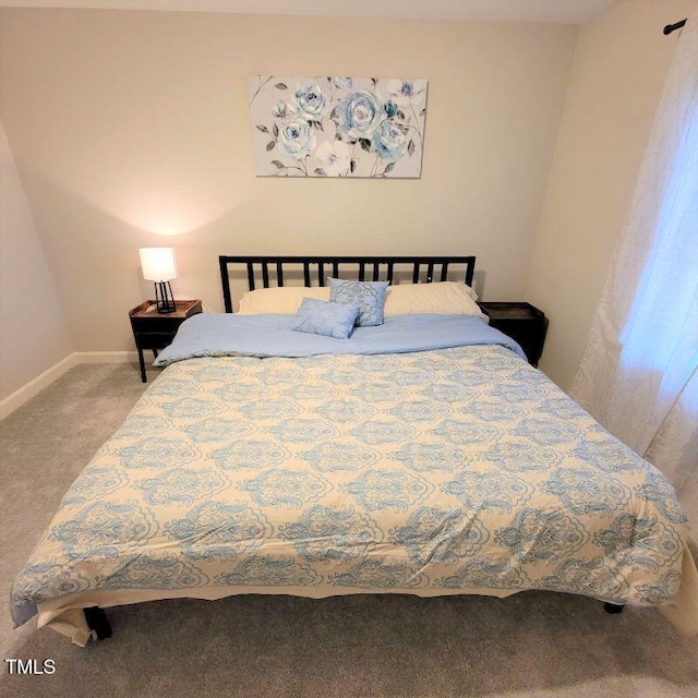 bedroom with carpet and baseboards