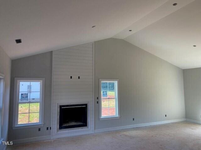 unfurnished living room featuring lofted ceiling, baseboards, and a large fireplace