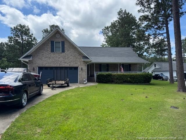 49 Pebble Beach Pt, Sanford, NC 27332 - view of front facade featuring a front yard, a porch, driveway, and an attached garage