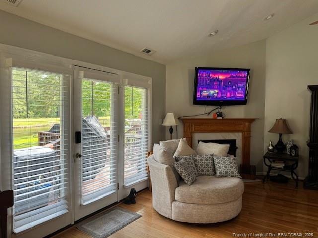 49 Pebble Beach Pt, Sanford, NC 27332 - sitting room featuring light wood-style floors, lofted ceiling, and a fireplace