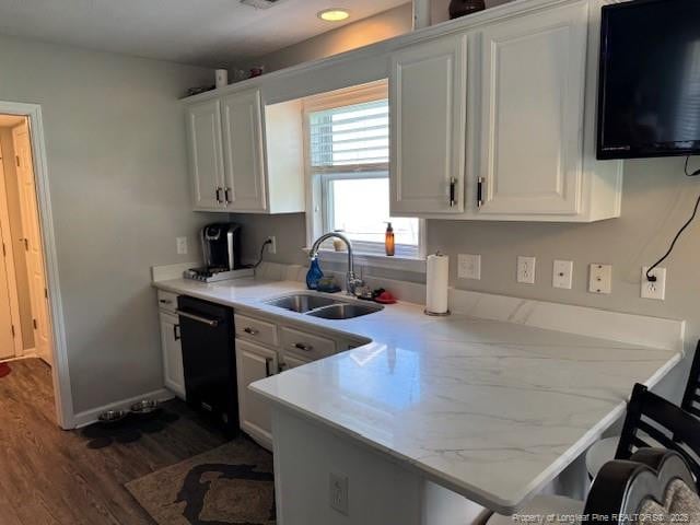 49 Pebble Beach Pt, Sanford, NC 27332 - kitchen with a sink, black dishwasher, a peninsula, dark wood-type flooring, and white cabinetry